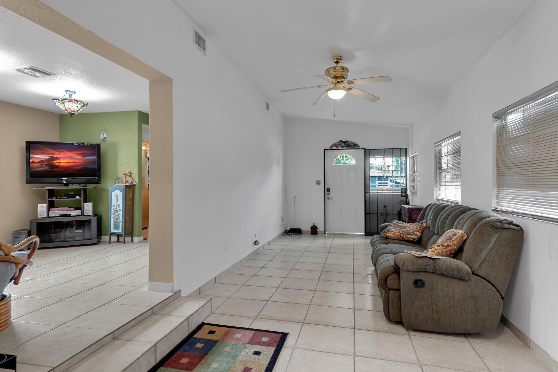 72 1st Court Key Largo, FL 33037 - Photo 4 of 30 a living room with furniture and a chandelier