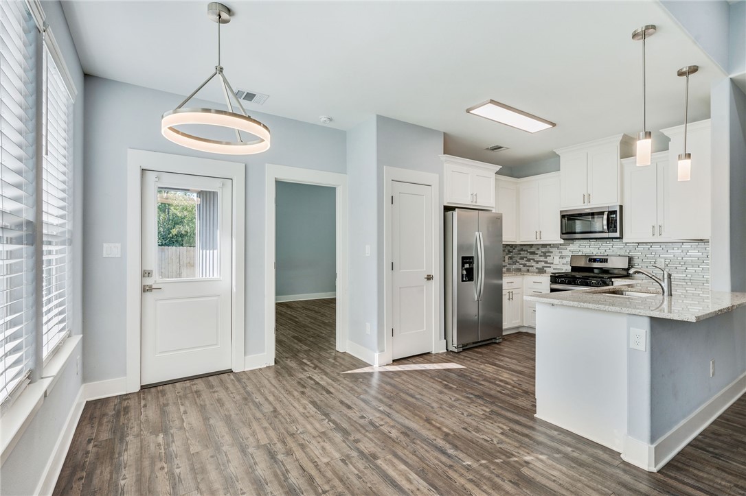 507 Walnut Street Bryan, TX 77803 - Photo 11 of 23 a kitchen view with stainless steel appliances a refrigerator and a stove top oven