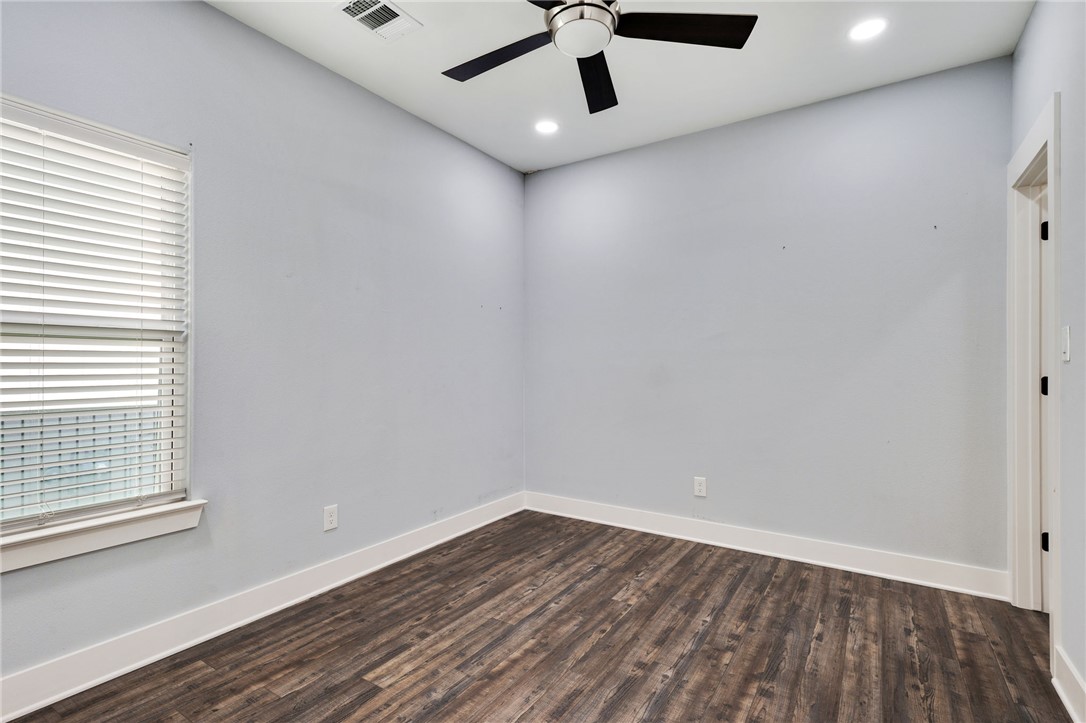507 Walnut Street Bryan, TX 77803 - Photo 12 of 23 wooden floor in an empty room with a window