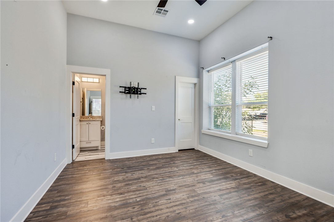 507 Walnut Street Bryan, TX 77803 - Photo 19 of 23 a view of an empty room with wooden floor and a window