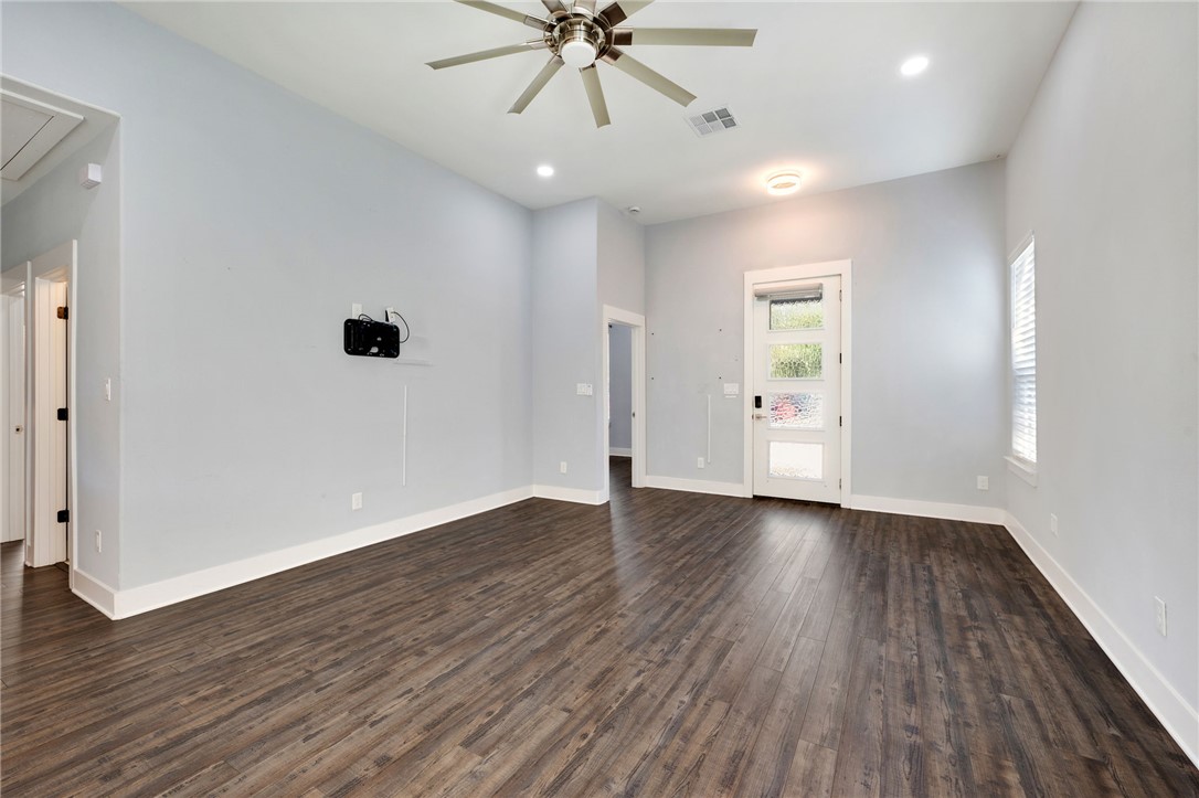 507 Walnut Street Bryan, TX 77803 - Photo 8 of 23 an empty room with wooden floor fan and windows