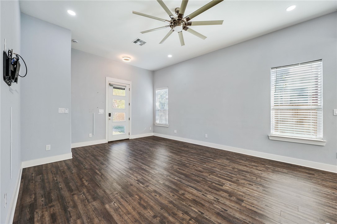 507 Walnut Street Bryan, TX 77803 - Photo 9 of 23 an empty room with wooden floor and windows