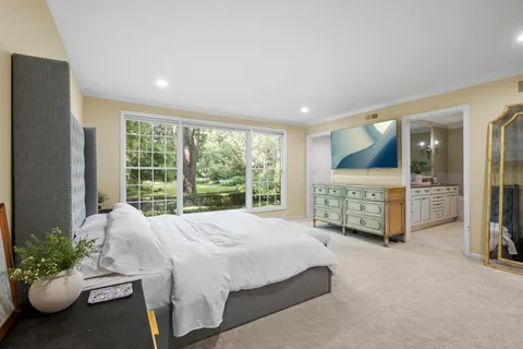 a spacious bedroom with a bed and a walk in closet