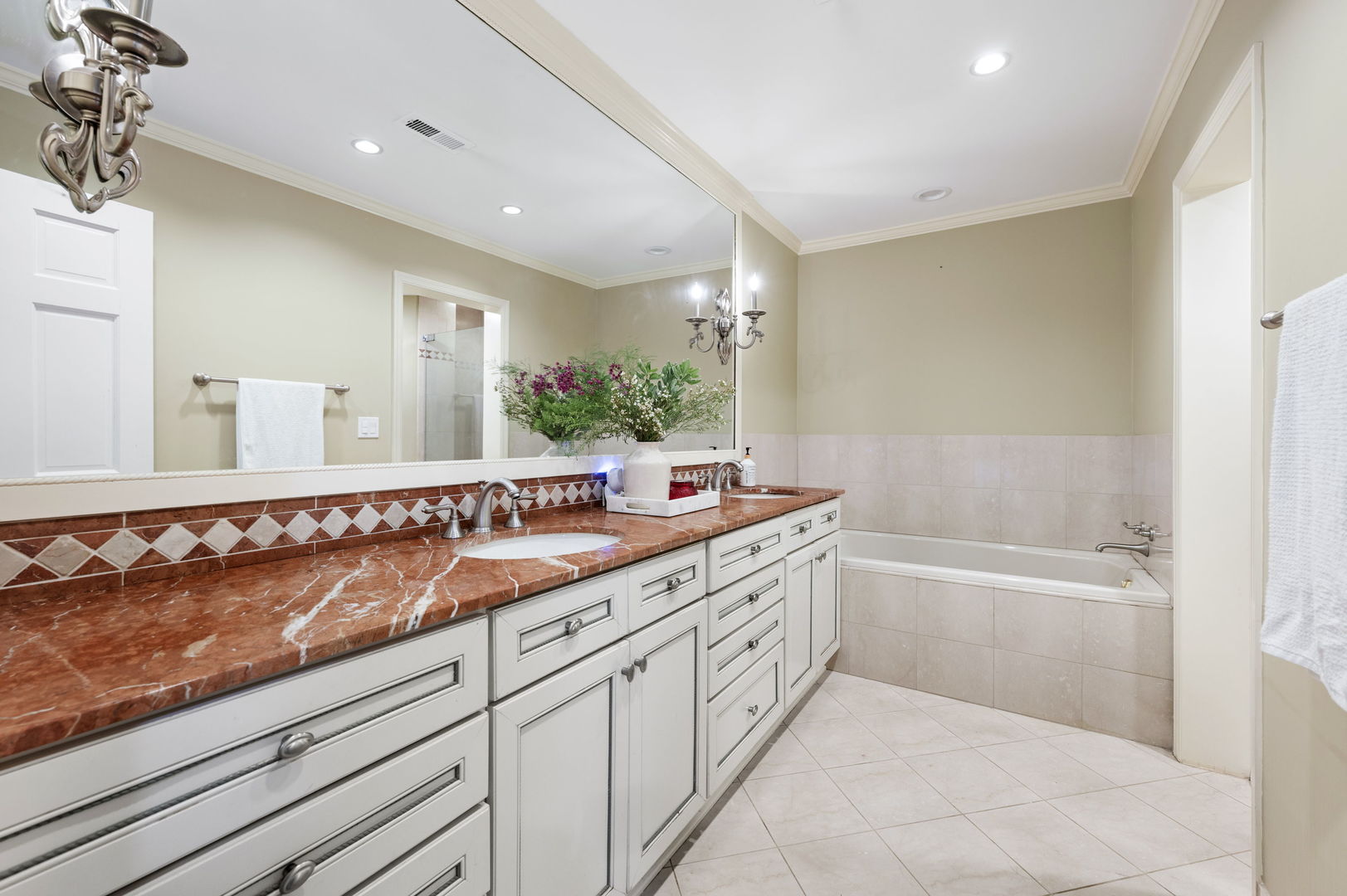 250 South Sheridan Road Lake Forest, IL 60045 - Photo 16 of 30 a bathroom with a double vanity sink a mirror and a bathtub