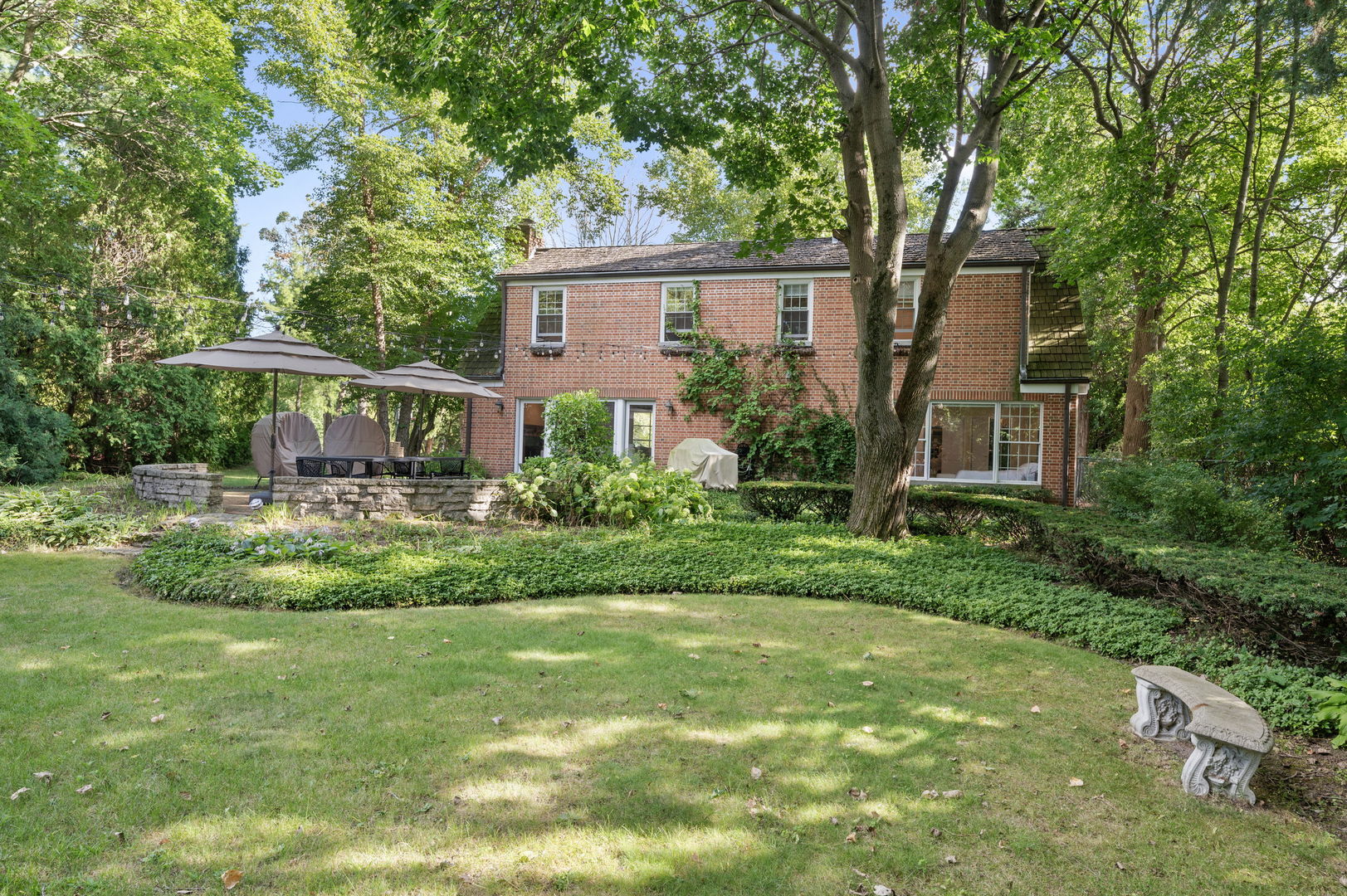 250 South Sheridan Road Lake Forest, IL 60045 - Photo 26 of 30 a front view of a house with a yard and a garden