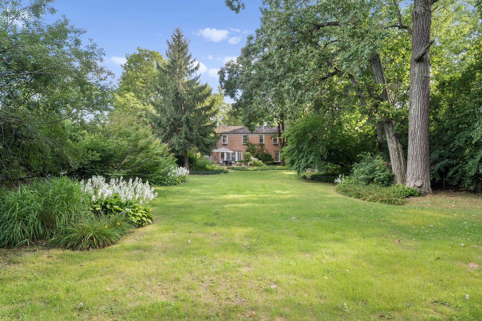 250 South Sheridan Road Lake Forest, IL 60045 - Photo 3 of 30 a view of a big yard with plants and large trees