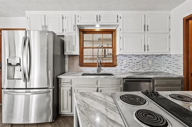 a view of a living room kitchen and a window