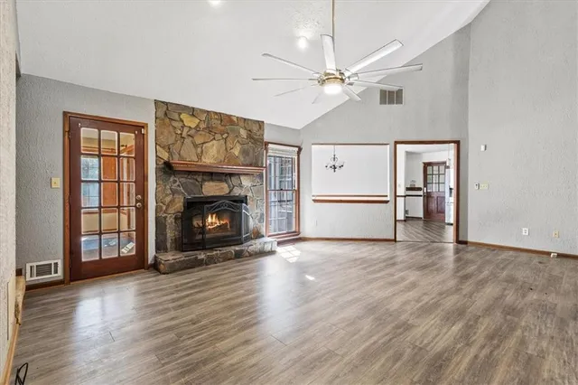 a view of a livingroom with a refrigerator and an entryway