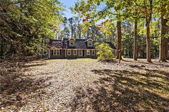 a view of an empty room with window and fire place