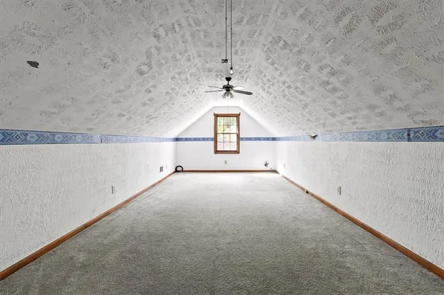 a view of a house with pool and wooden fence