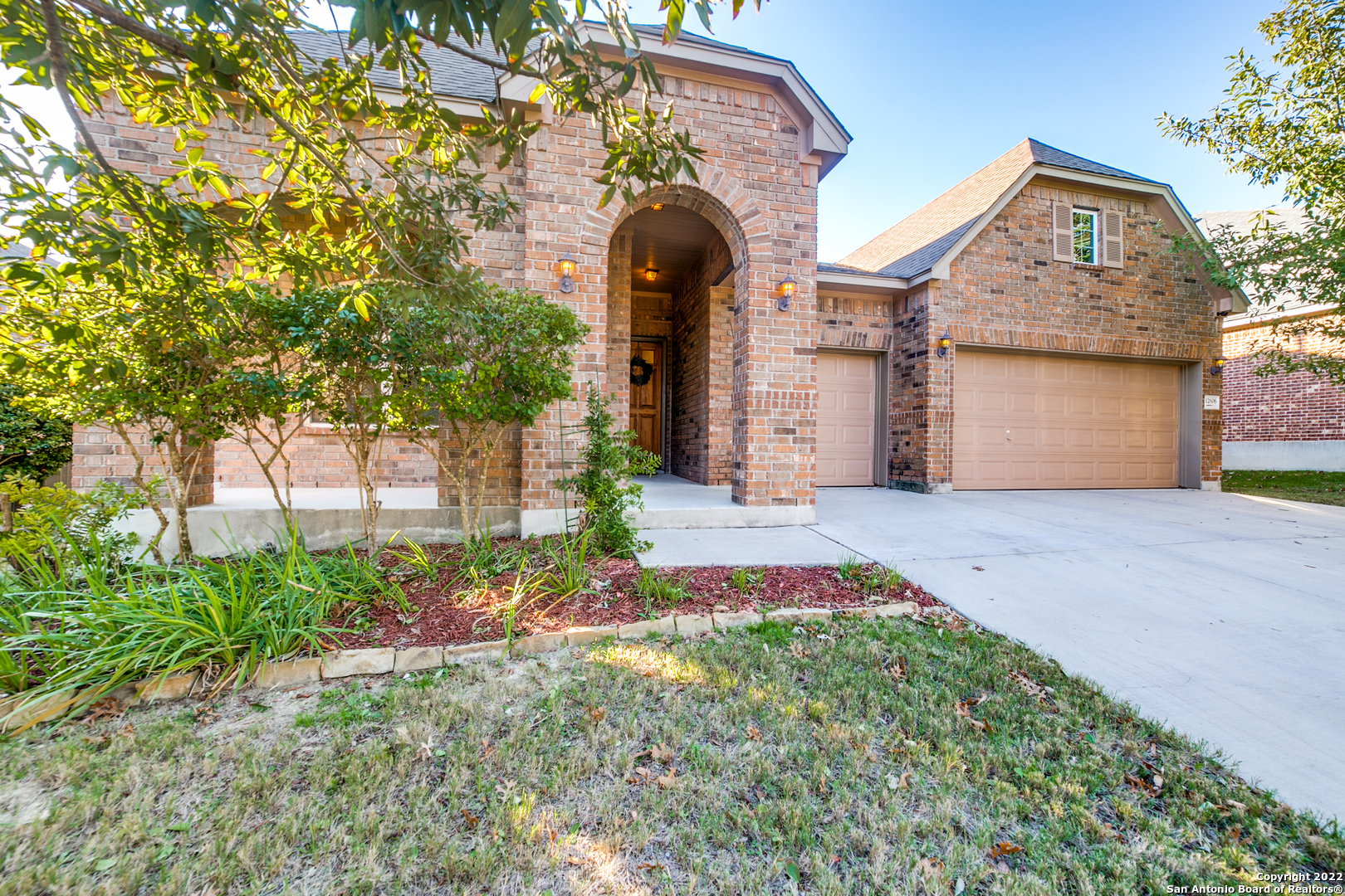 a front view of a house with garden
