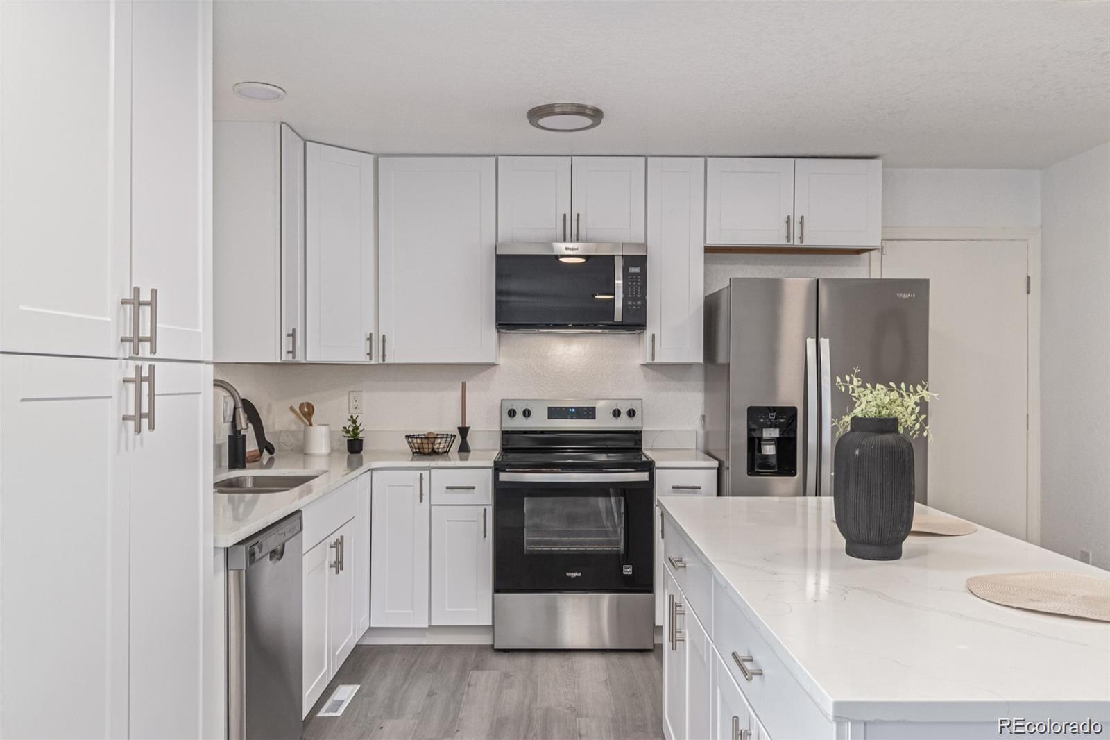 9495 Webster Way Broomfield, CO 80021 - Photo 13 of 32 a kitchen with a sink a stove and refrigerator