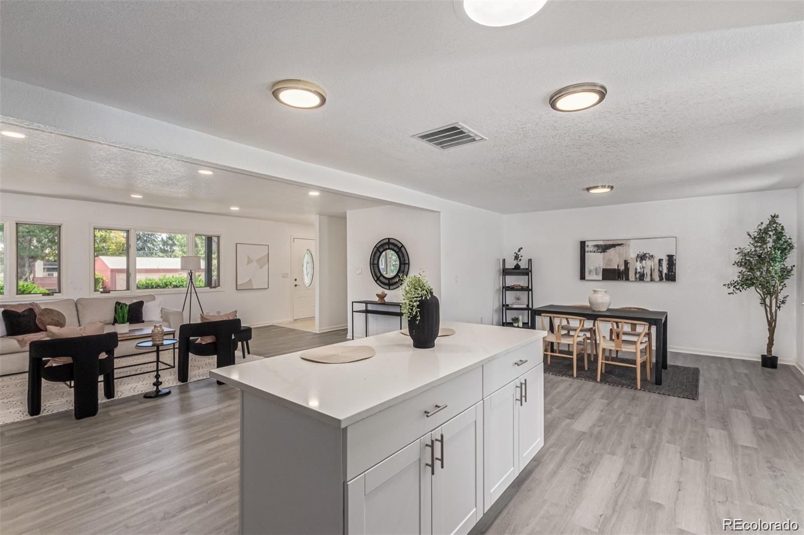 9495 Webster Way Broomfield, CO 80021 - Photo 14 of 32 a large living room with stainless steel appliances granite countertop furniture and wooden floor