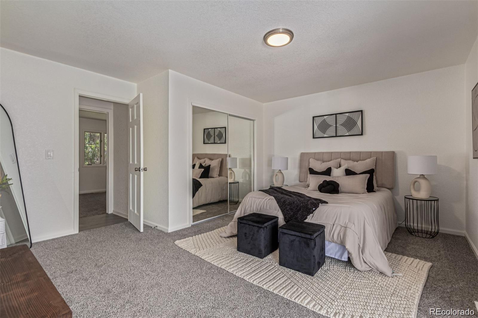9495 Webster Way Broomfield, CO 80021 - Photo 16 of 32 a bedroom with a bed and a couch