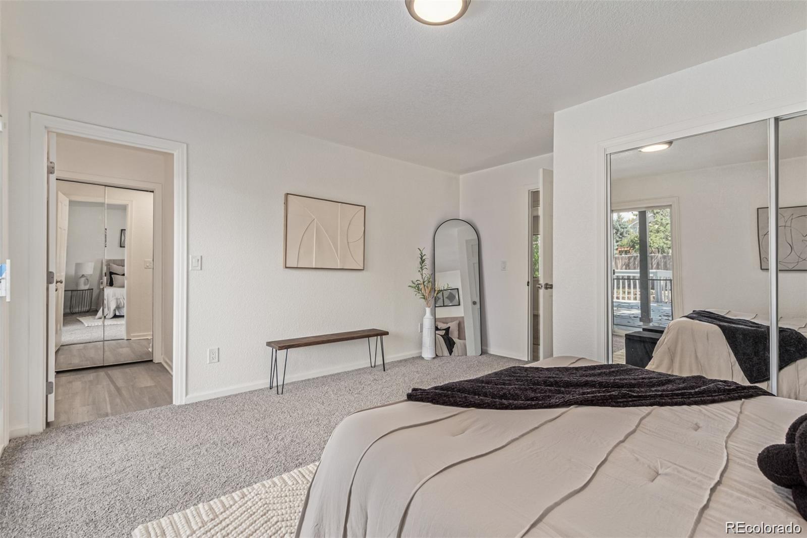 9495 Webster Way Broomfield, CO 80021 - Photo 17 of 32 a bedroom with a bed and a mirror