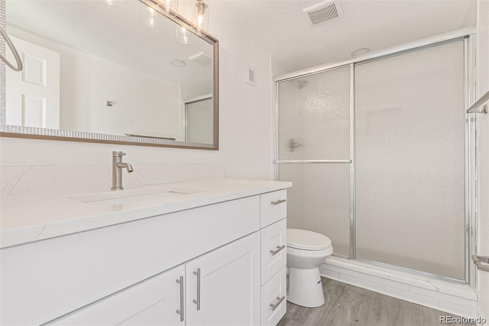 9495 Webster Way Broomfield, CO 80021 - Photo 21 of 32 a bathroom with a sink a toilet and shower