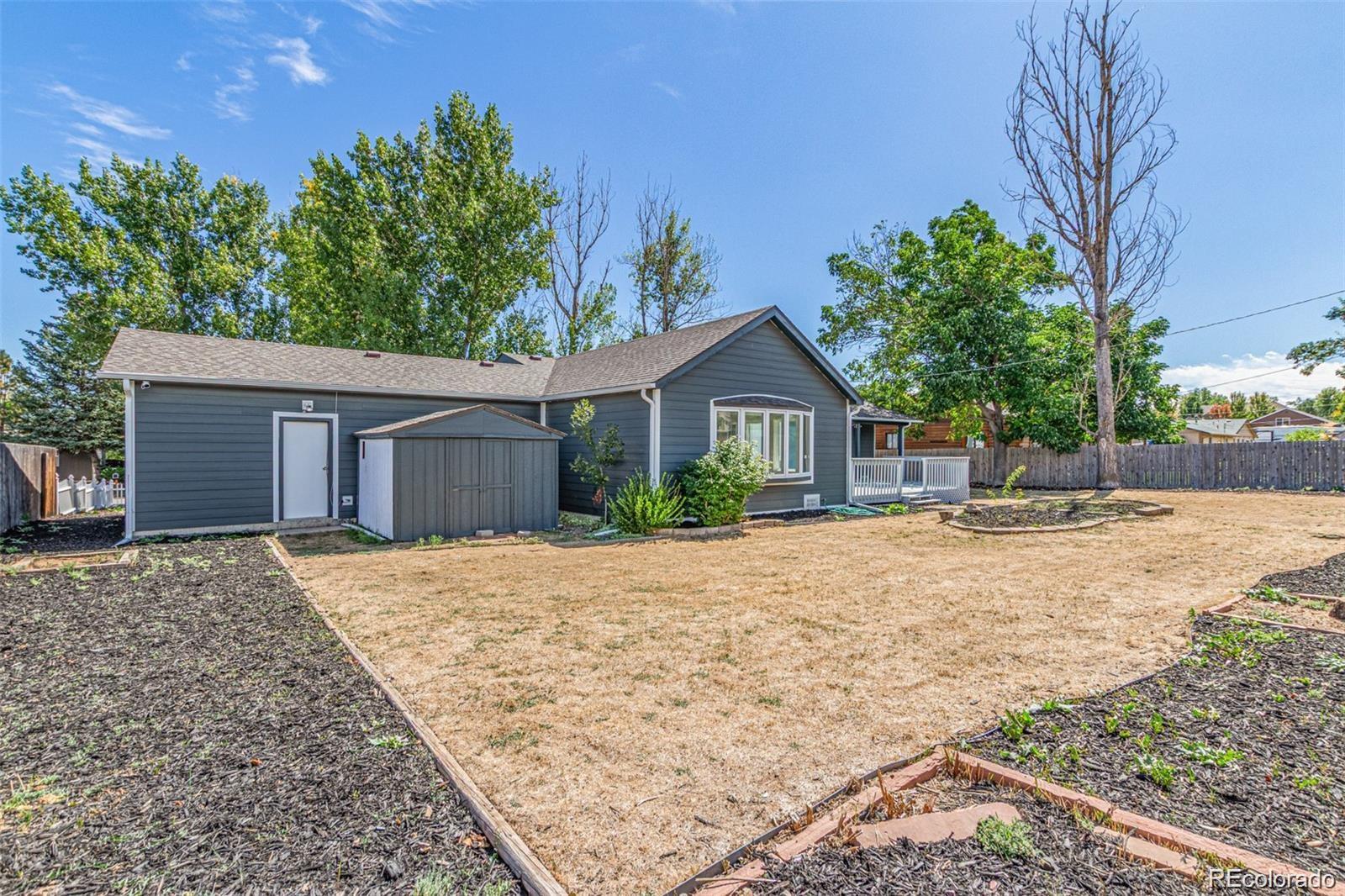 9495 Webster Way Broomfield, CO 80021 - Photo 29 of 32 a front view of a house with a yard and garage