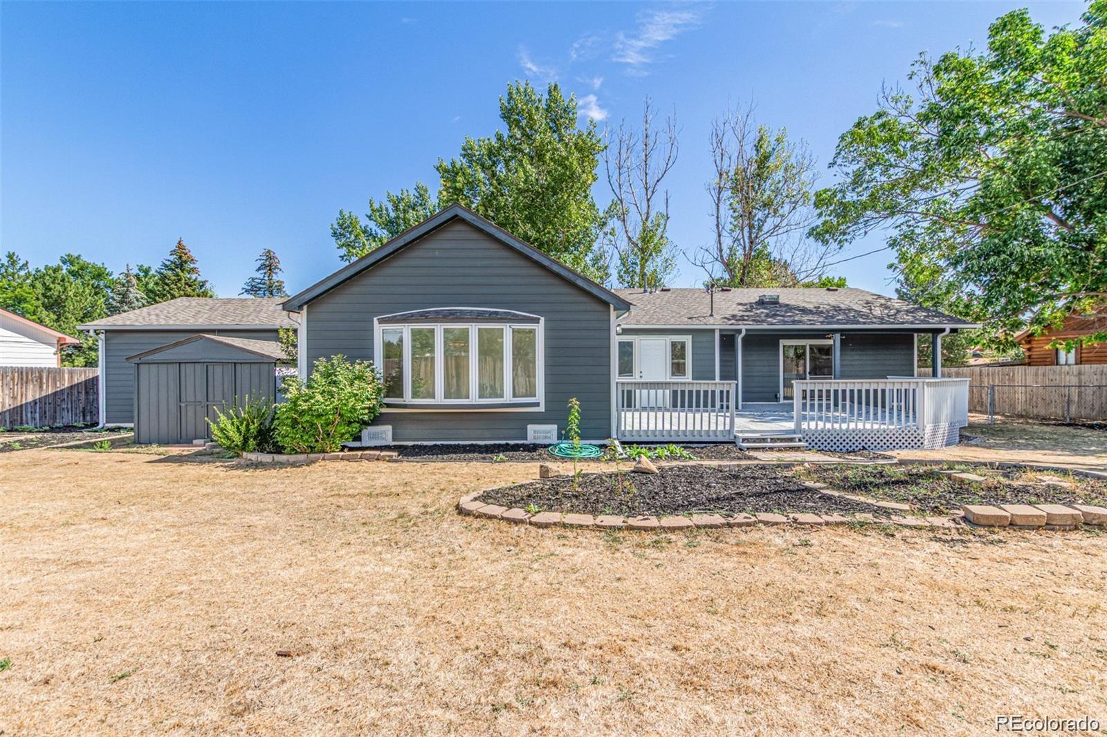 9495 Webster Way Broomfield, CO 80021 - Photo 30 of 32 a front view of a house with a garden