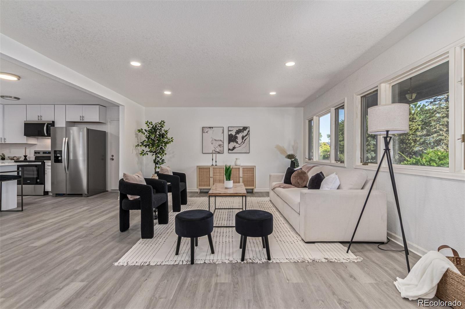 9495 Webster Way Broomfield, CO 80021 - Photo 6 of 32 a living room with furniture a large window and wooden floor