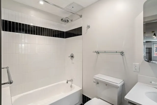 a bathroom with a shower a toilet and sink