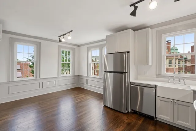 a kitchen with stainless steel appliances a refrigerator sink and cabinets