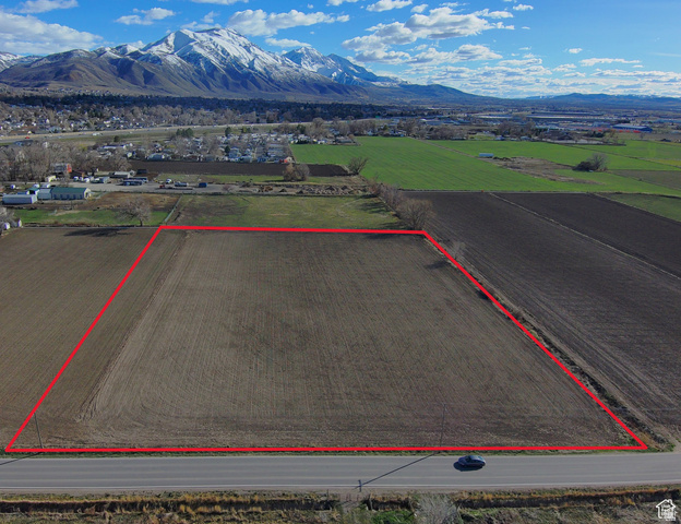 Overview of rural landscape featuring property boundaries highlighted and a mountainous background