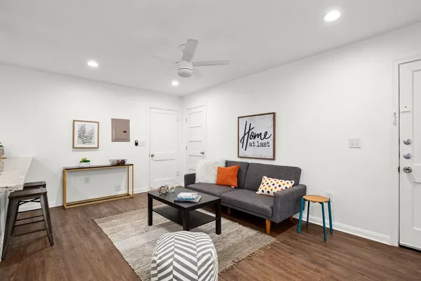 a living room with furniture and wooden floor