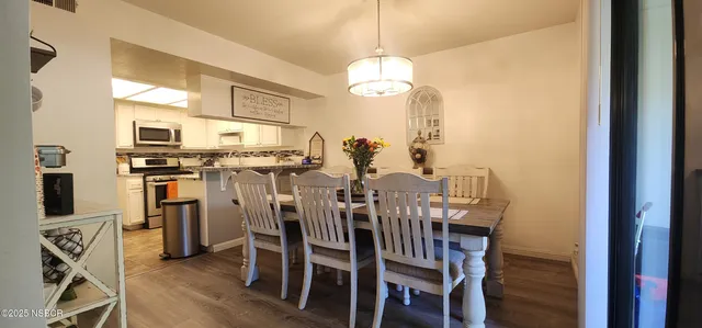 a view of a dining room with furniture window and wooden floor