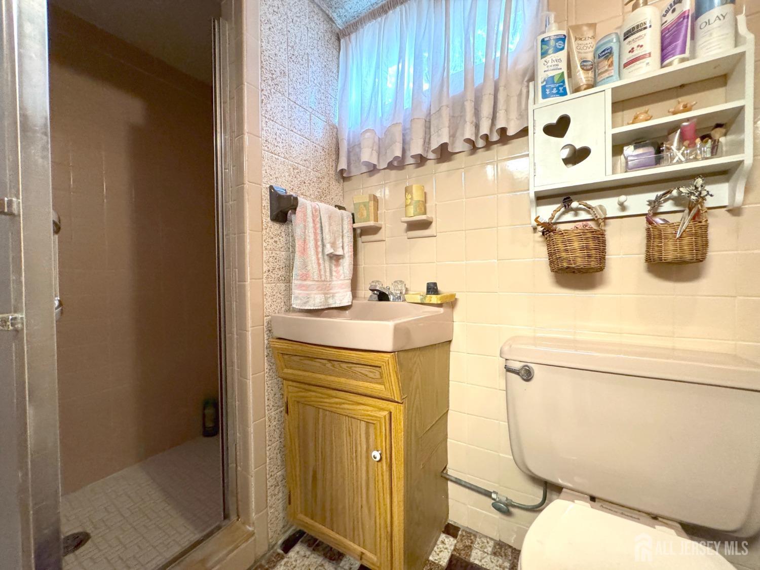 123 Crestview Road Fords, NJ 08863 - Photo 24 of 31 a bathroom with a sink a toilet and shower curtain