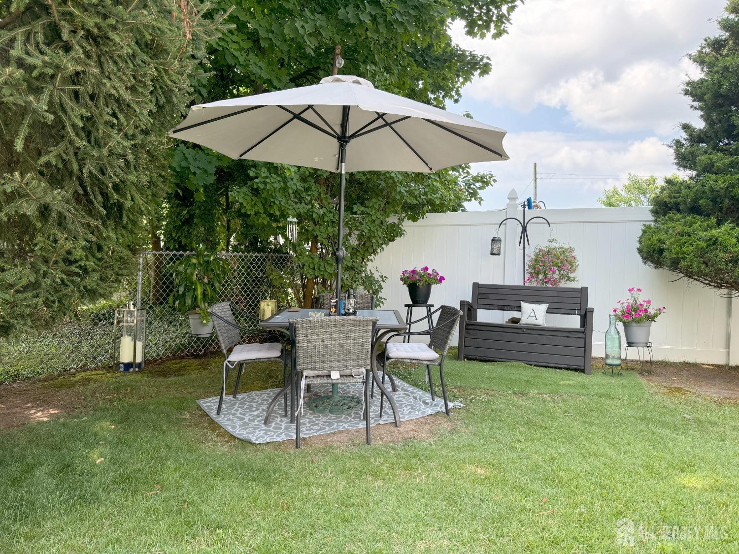 123 Crestview Road Fords, NJ 08863 - Photo 28 of 31 a patio with a table and chairs under an umbrella