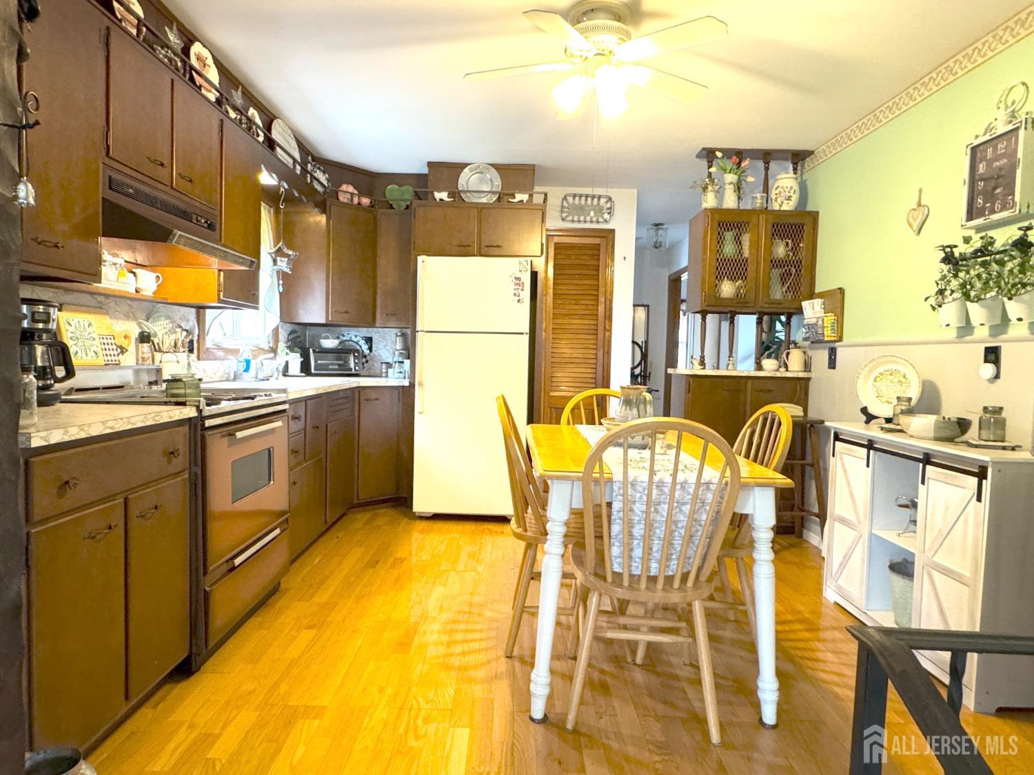 123 Crestview Road Fords, NJ 08863 - Photo 8 of 31 a kitchen with stainless steel appliances kitchen island granite countertop a table and chairs