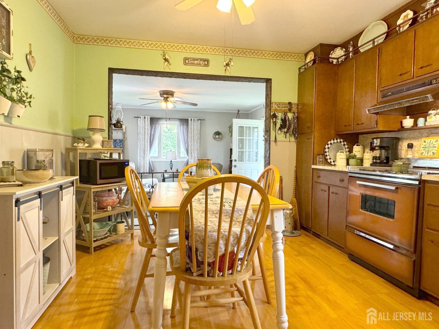 123 Crestview Road Fords, NJ 08863 - Photo 9 of 31 a view of a kitchen with stainless steel appliances kitchen island granite countertop a table chairs in it