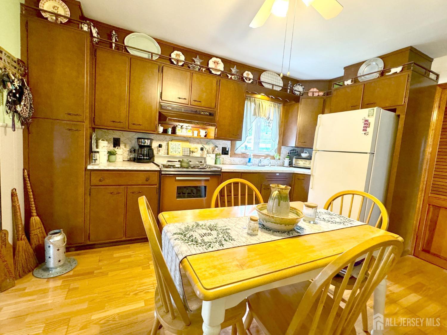 123 Crestview Road Fords, NJ 08863 - Photo 10 of 31 a kitchen with a table chairs and refrigerator