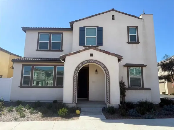 a view of a house with large windows and a yard