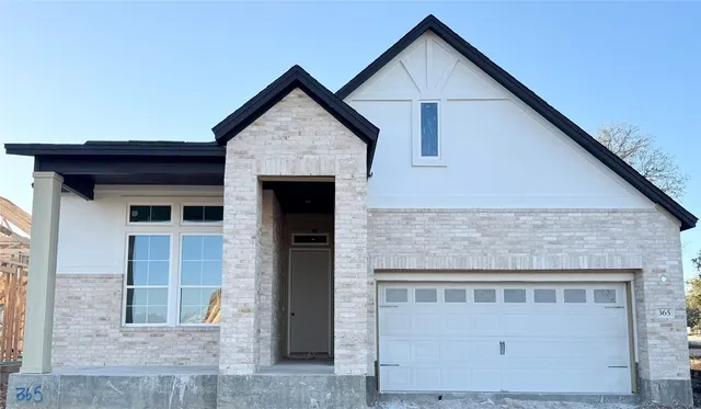 a front view of a house with a garage