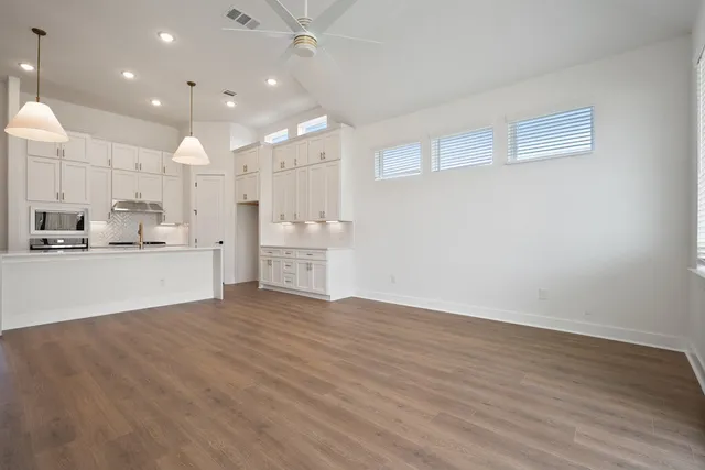 a bathroom with a double vanity sink a mirror and shower