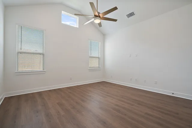 a bathroom with a granite countertop sink a toilet and shower