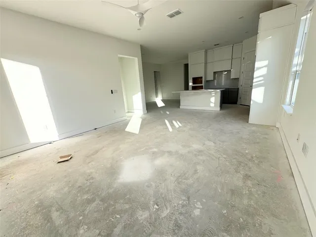 a view of a kitchen with furniture and wooden cabinets