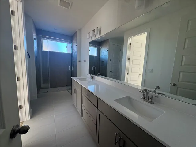 a bathroom with a double vanity sink a and mirror
