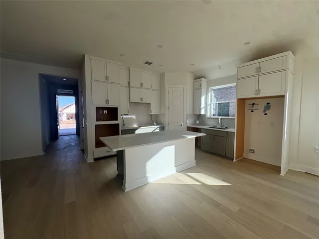 a kitchen with stainless steel appliances a sink a stove a refrigerator and cabinets