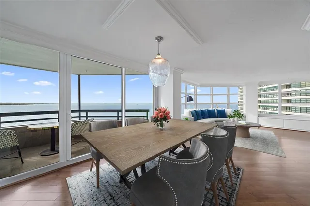 a view of a kitchen with wooden floor and electronic appliances