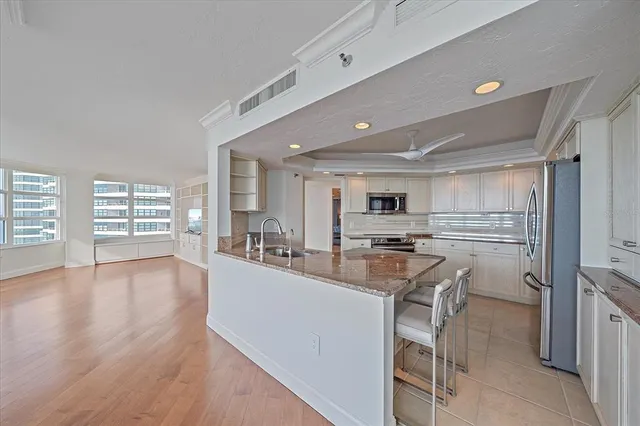 a kitchen with a table chairs microwave and cabinets