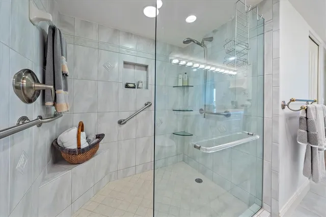 a view of empty room with windows and chandelier fan