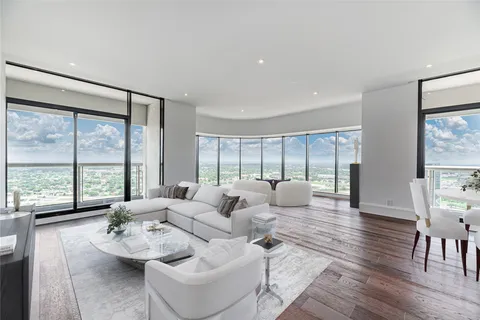 a spacious bedroom with furniture and a large window