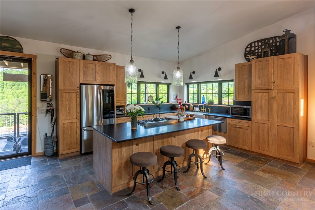 509 Grant Houck Road Todd, NC 28684 - Photo 15 of 43 a kitchen with stainless steel appliances granite countertop a refrigerator a sink a stove and a refrigerator