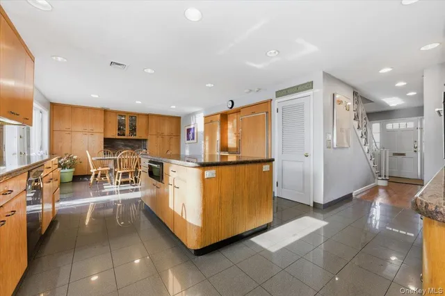 a kitchen with stainless steel appliances a refrigerator and a stove top oven