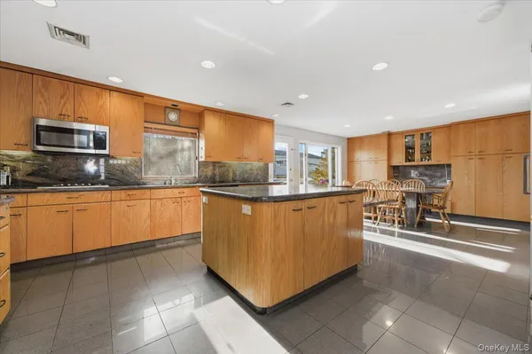 a kitchen with stainless steel appliances granite countertop a stove top oven a sink a counter top space and cabinets