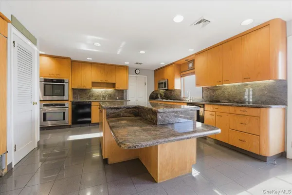 a kitchen with sink cabinets and stainless steel appliances