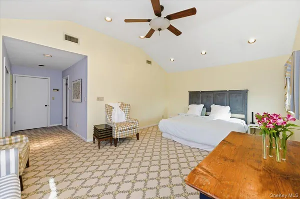 a bedroom with a bed and a potted plant