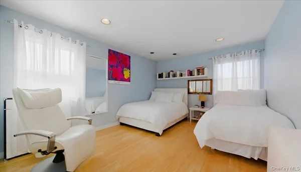a bedroom with a bed wooden floor and a window